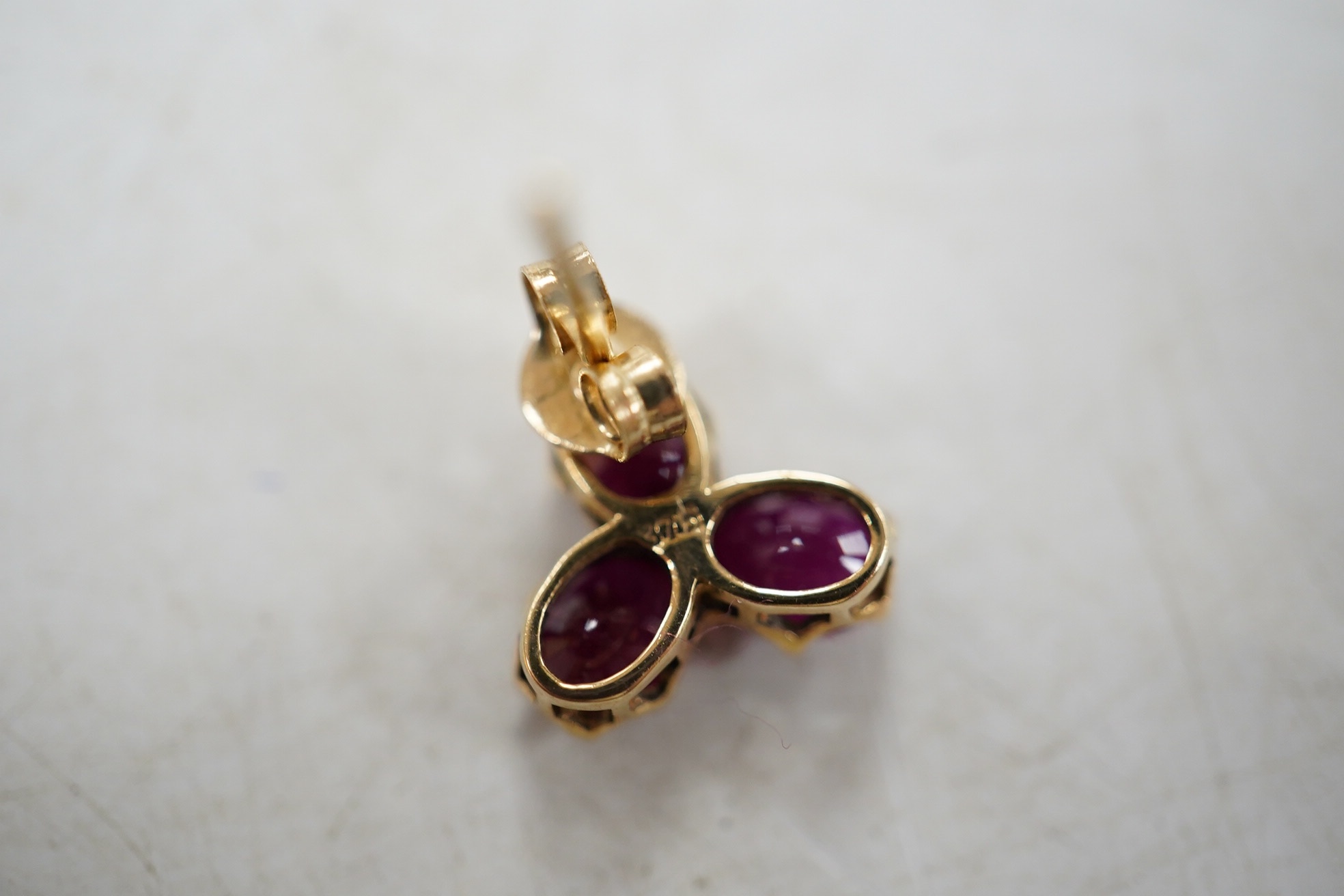 A modern pair of 9ct gold and three stone ruby cluster set ear studs, 9mm, gross weight 1.6 grams. Condition - good